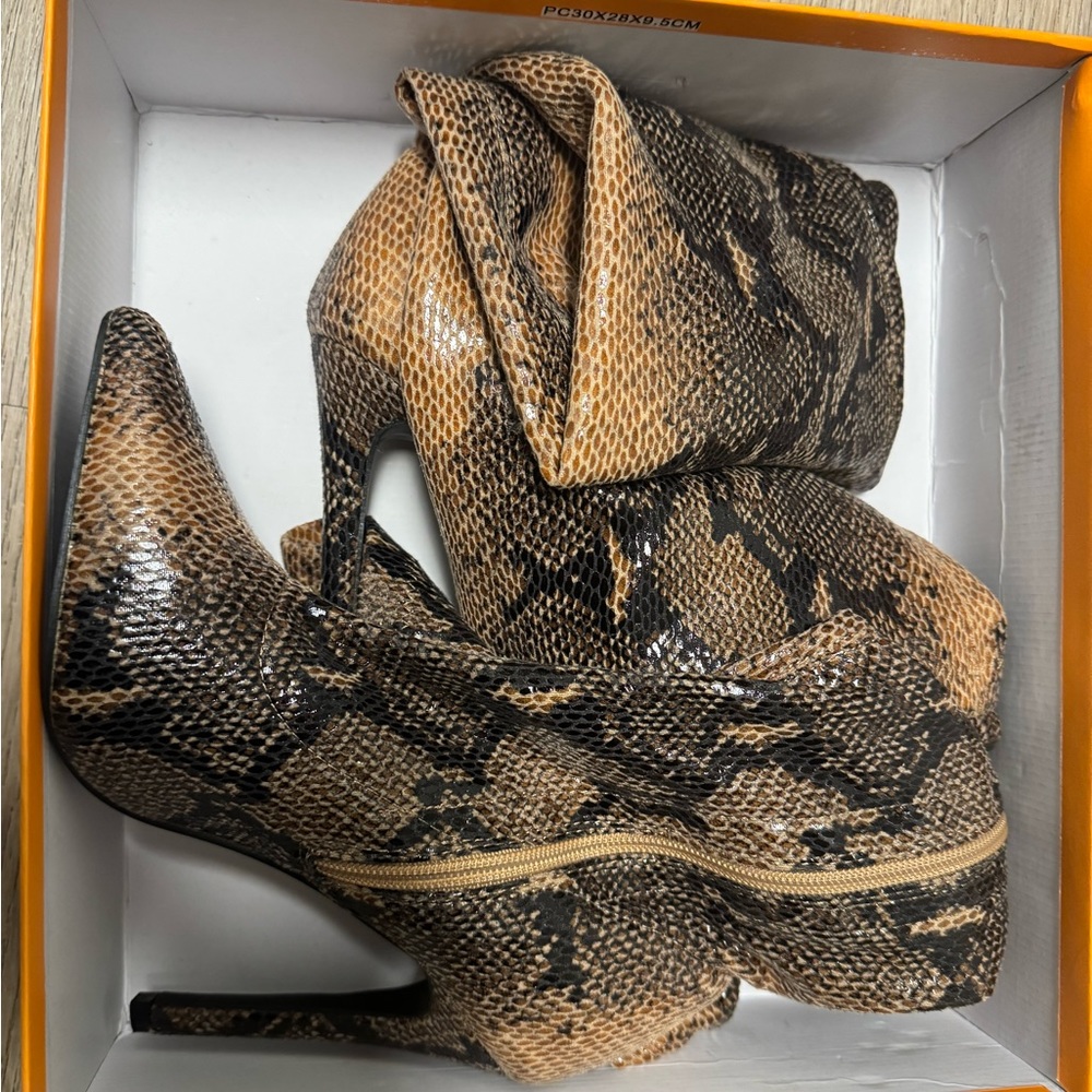 Tan Snake knee high boots .